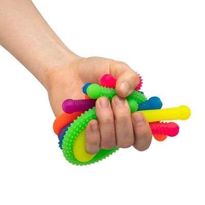 Hand squeezing six flexible, textured neon noodle toys in bright pink, yellow, green, blue, and purple.