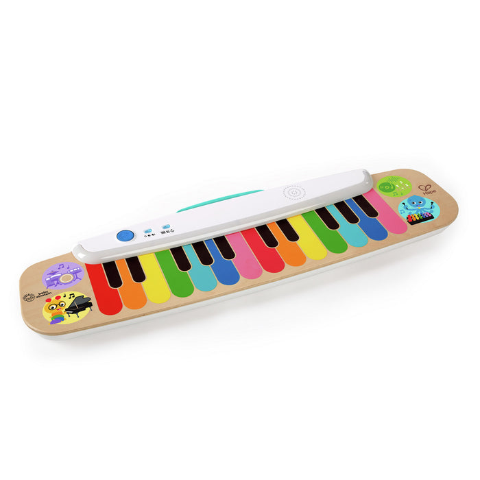Flat wooden toy keyboard featuring rainbow keys, a white electronic bar, and colorful musical animal icons.