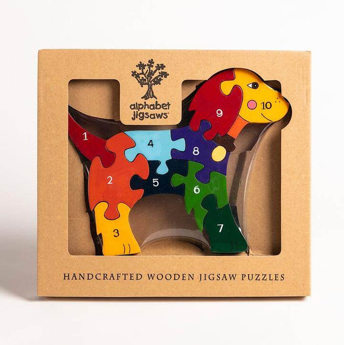 Colorful dog-shaped wooden puzzle with pieces numbered 1-10 inside a cardboard window box.