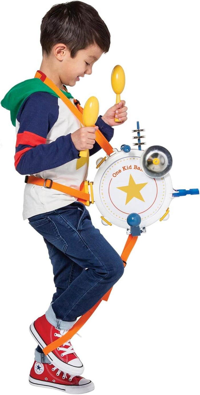 Child playing a wearable drum toy with yellow maracas, a cymbal, and a bell while marching in red sneakers.