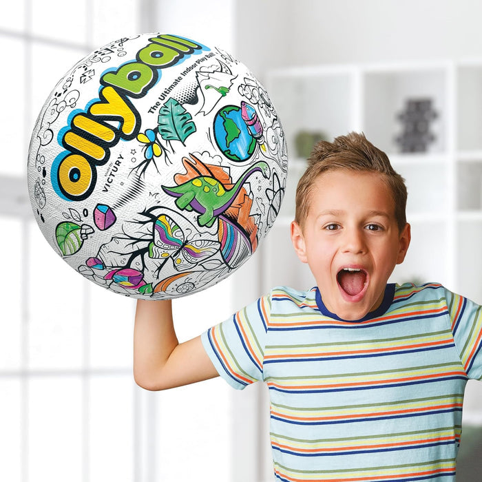 Excited boy holding a large white ball with black line art of a dinosaur and Earth, with some sections colored in.