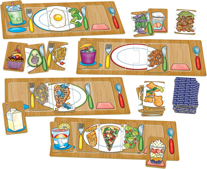 Four placemats with colorful cartoon food cards, including pizza, broccoli, and silly items like steak with flies.