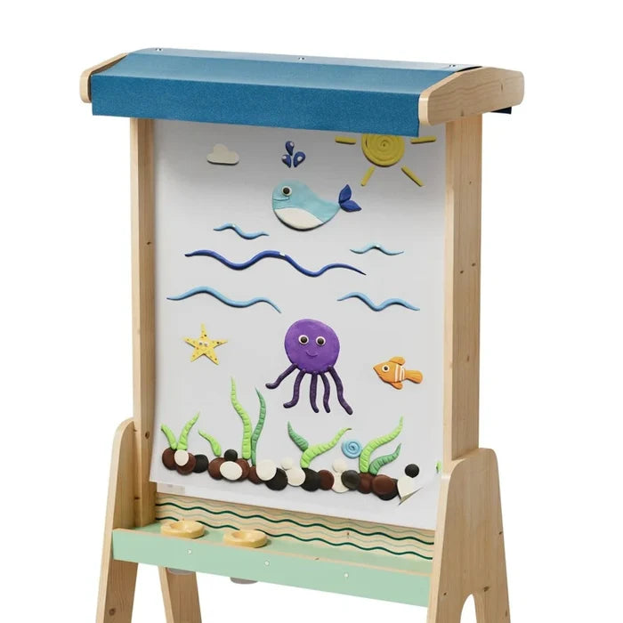 Wooden outdoor easel with blue awning and white board featuring colorful clay sea creatures and a green base tray.