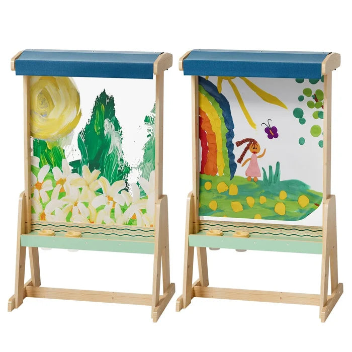 Two wooden outdoor easels with blue roofs and green trays, featuring colorful nature paintings on clear panels.