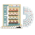 Wooden 4-level parking garage toy with sliding pastel cars, a vertical lift, and color-matching challenge cards.
