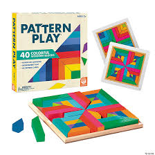 Colorful geometric wooden blocks in a square tray with sample pattern cards and the product box.