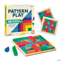 Colorful geometric wooden blocks in a square tray with sample pattern cards and the product box.