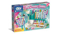 Teal and pink toy box showing a pen-making station with glitter, beads, and 10 colorful pens with animal toppers.