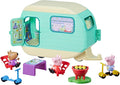 Mint green toy caravan set with three figures, red chairs, purple table, grill, and scooters.