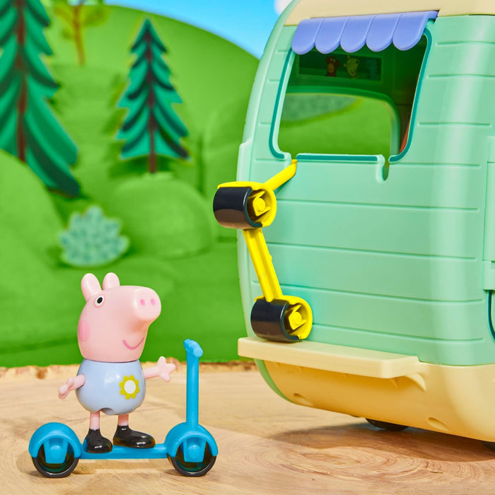 Peppa Pig toy on a blue scooter next to a light green caravan with a yellow rack holding more scooters.