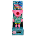 Pink pig squeeze toy wearing a floral green Hawaiian shirt with a large open mouth, in teal packaging.