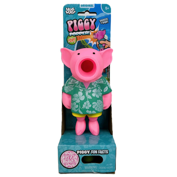 Pink pig squeeze toy wearing a floral green Hawaiian shirt with a large open mouth, in teal packaging.