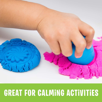Child's hand stamping pink sand next to a patterned blue sand disk. Green banner reads Great for calming activities.