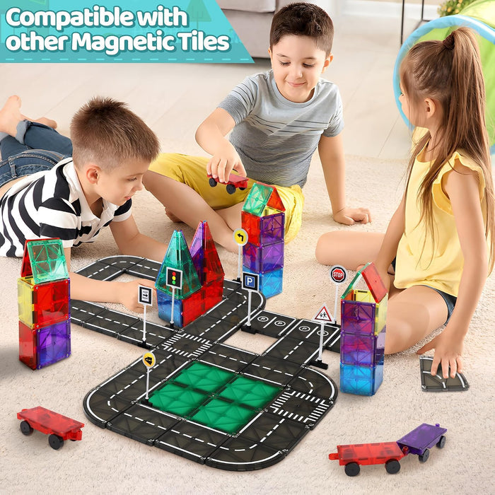 Three children build a road track and colorful towers with translucent magnetic tiles, toy cars, and road signs.