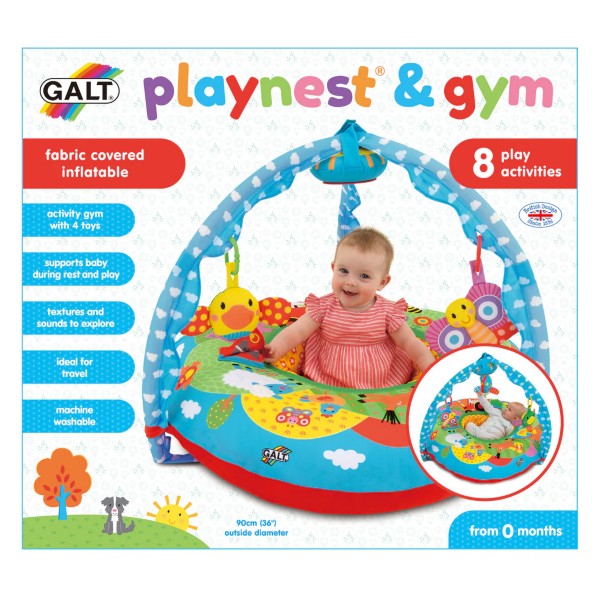 Baby in a colorful farm-themed inflatable ring with a blue overhead toy arch and hanging animal toys on packaging.