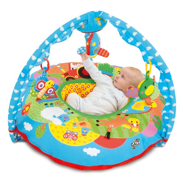 Colorful circular inflatable farm-themed baby nest with a blue overhead arch and hanging plush toys.