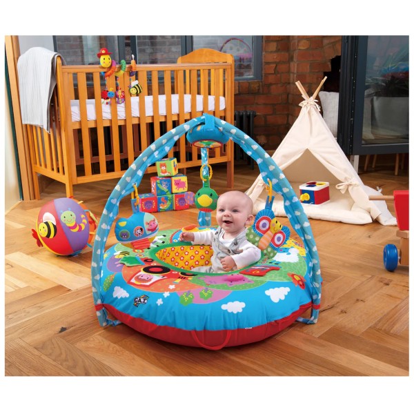 Baby sitting in a circular inflatable blue farm-themed activity nest with overhead arches and hanging plush toys.