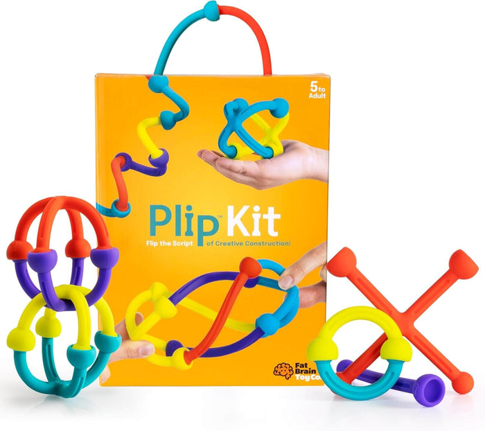 Colorful flexible construction toys in rings and 3D shapes around a yellow Plip Kit box for ages 5 to adult.