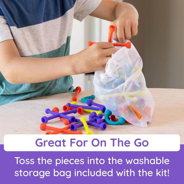 Child placing colorful silicone suction cup pieces into a white mesh drawstring storage bag.