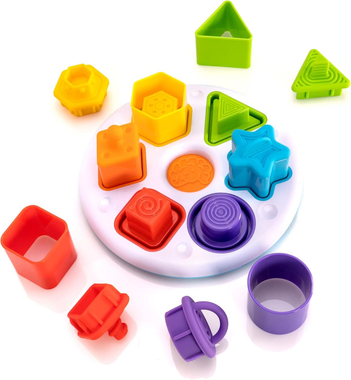 Colorful shape sorter featuring a white base and textured geometric pieces in bright green, blue, purple, red, and orange.