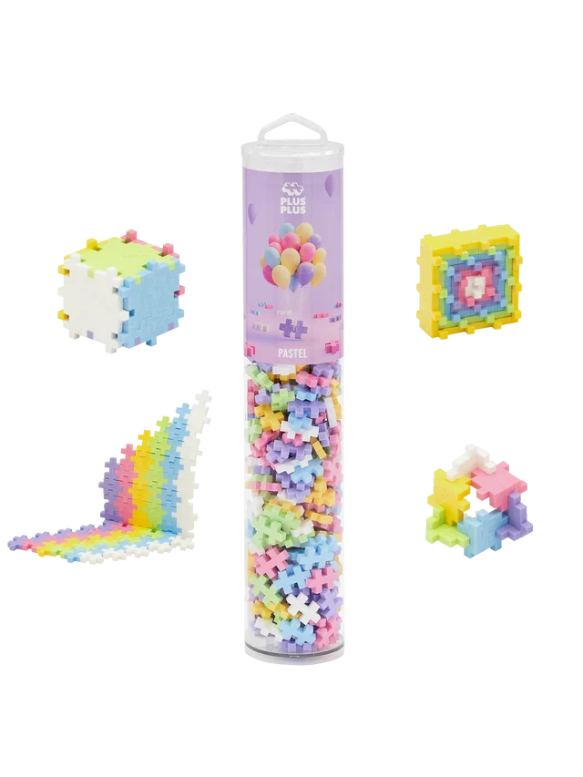 Clear tube of pastel plus-shaped blocks with 3D and 2D example builds including a cube, square, and colorful wave.