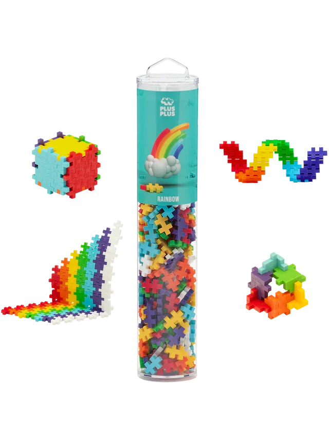 Clear tube of rainbow plus-shaped interlocking blocks with sample builds: a cube, wavy lines, and a geometric ring.
