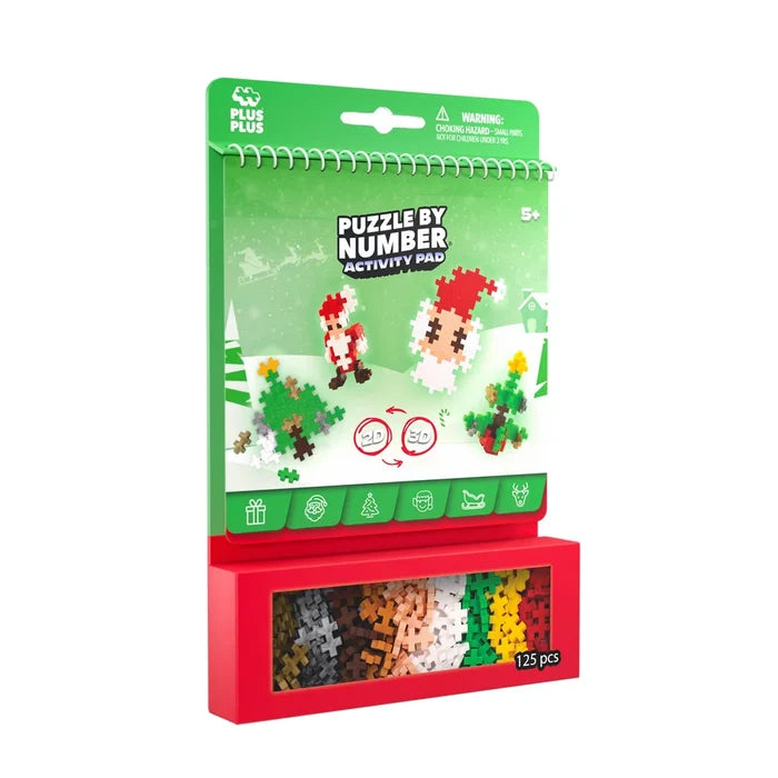 Green Christmas activity pad with Santa pixel art and a red box containing 125 colorful plus-shaped building pieces.