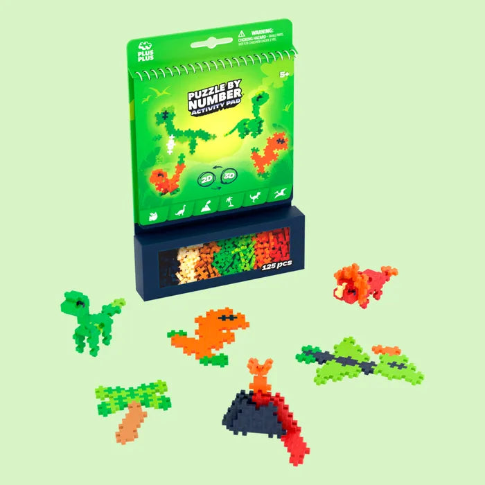 Green dinosaur activity pad with 125 colorful pieces and finished 2D and 3D dinosaur and volcano models.