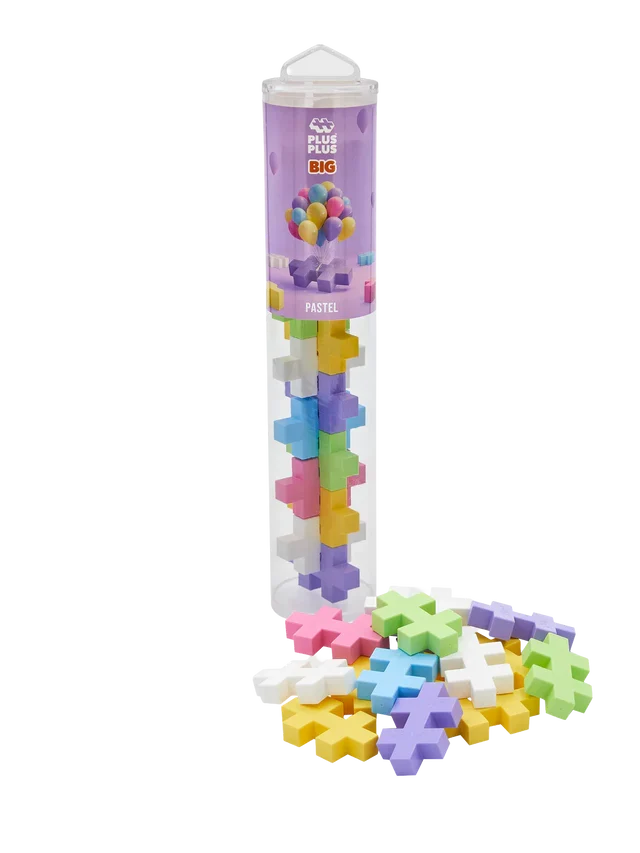 Pastel plus-shaped building blocks inside a clear plastic tube and scattered in a pile on a white background.