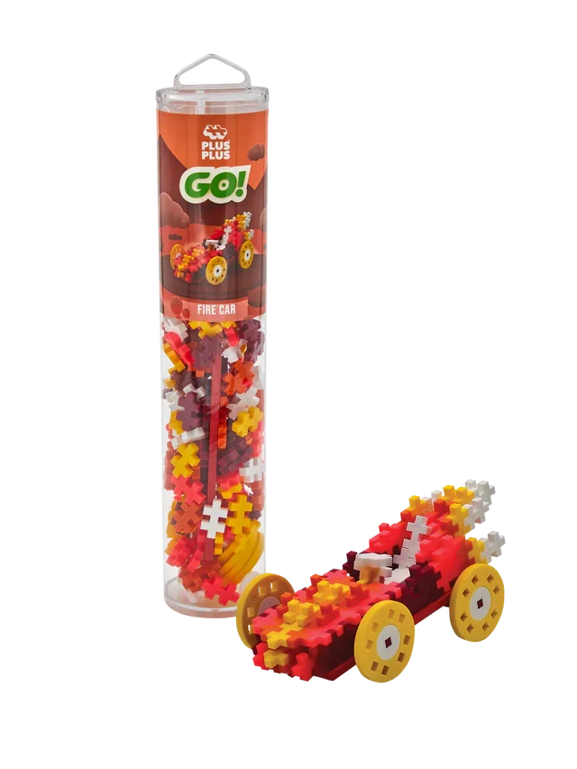 Red and yellow fire car built from plus-shaped blocks next to a clear tube of colorful building pieces.
