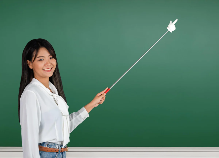 Silver telescopic pointer with a red handle and white gloved hand tip, held by a woman against a green chalkboard.