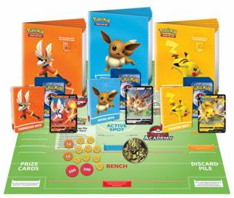 Game set with Eevee, Pikachu, and Cinderace decks, manuals, and oversized cards on a green playmat with damage counters.