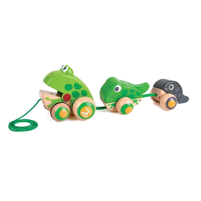 Wooden pull toy with three frog figures on wheels: a large green frog, a smaller green frog, and a black tadpole.