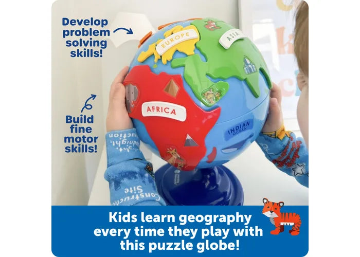 Child holding a blue toy globe with colorful continent puzzle pieces labeled Africa, Europe, and Asia.