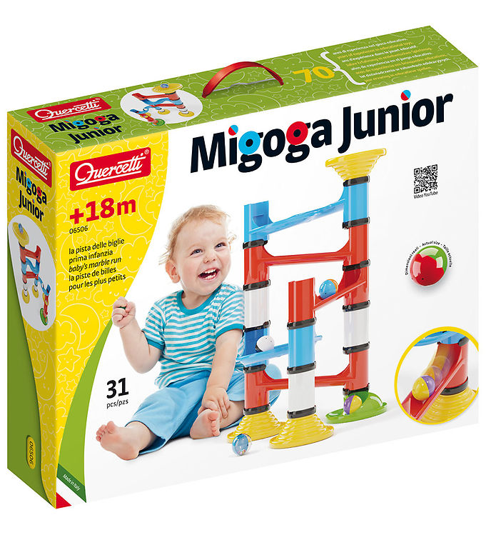 Toy box showing a toddler next to a colorful plastic ball track with red, blue, and yellow tubes and chunky balls.