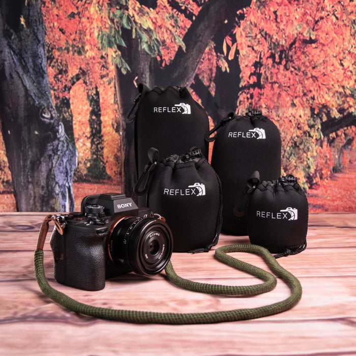 Sony camera displayed with Reflex lens pouches in autumn-themed background.