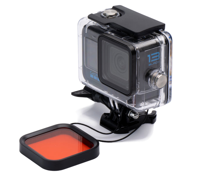 Action camera with a red filter attached on a white background