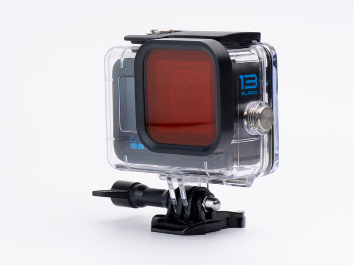 Action camera with a red filter and clear case on a white background