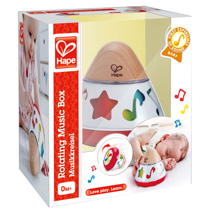 Conical baby music box with a wooden top and colorful notes, in packaging showing a baby playing with the toy.