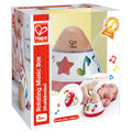 Conical baby music box with a wooden top and colorful notes, in packaging showing a baby playing with the toy.