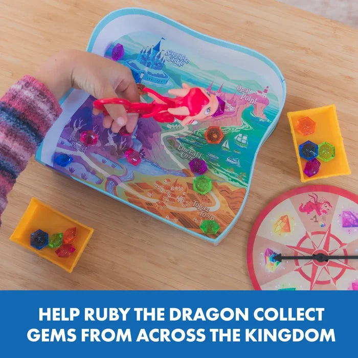 Child uses red dragon tweezers to pick up colorful gems from a fantasy map game board with a spinner and sorting trays.