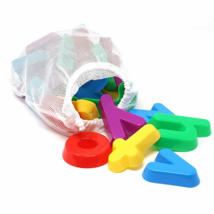 Colorful lowercase letter sand molds in a white mesh bag, with a red o, yellow t, and blue a spilling out.