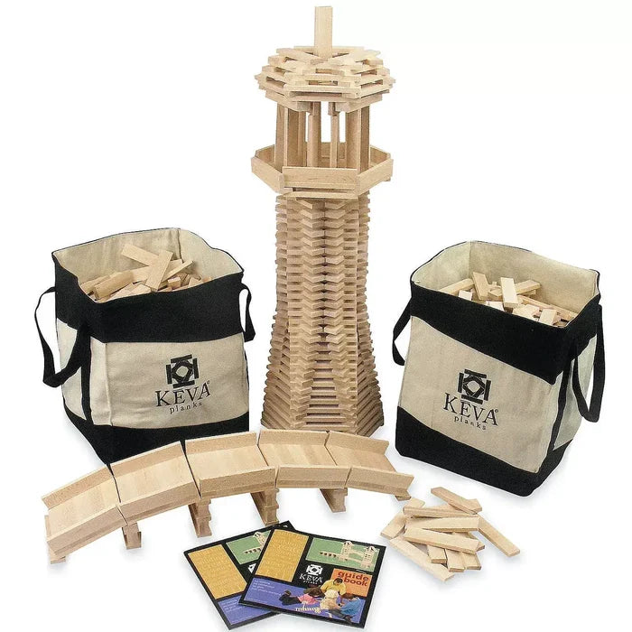 Tall natural wood tower and bridge shown with two canvas storage bags, loose building planks, and a guidebook.