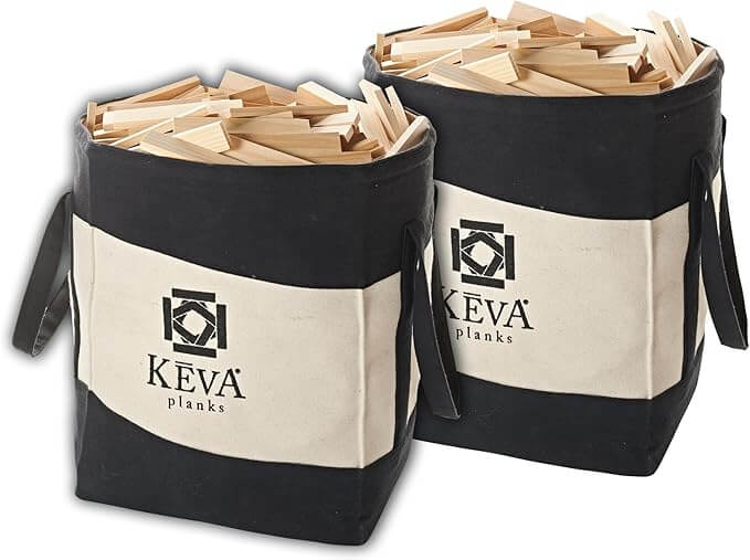 Two black and white canvas bags filled with hundreds of light-colored rectangular wooden building planks.