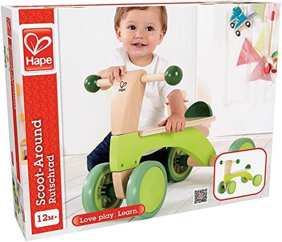 Lime green and wood four-wheel toddler ride-on bike in retail box featuring a child sitting on the seat.