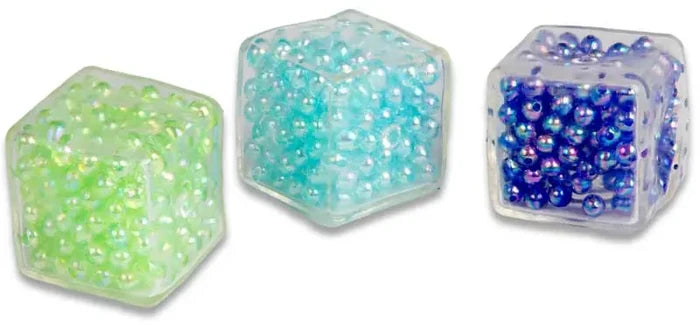 Three translucent cubes filled with small iridescent beads in lime green, light blue, and deep purple-blue.