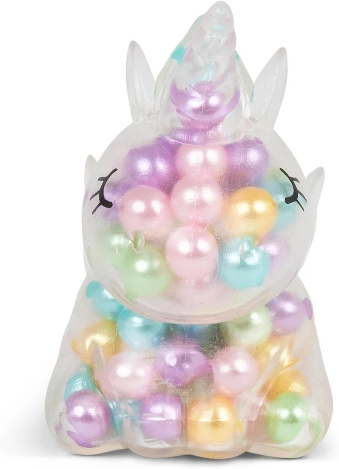 Translucent unicorn-shaped squishy toy filled with colorful pearlescent beads and featuring black eyelash details.
