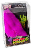 Neon purple squishy monster hand with red stitches in clear plastic packaging with monster illustrations.