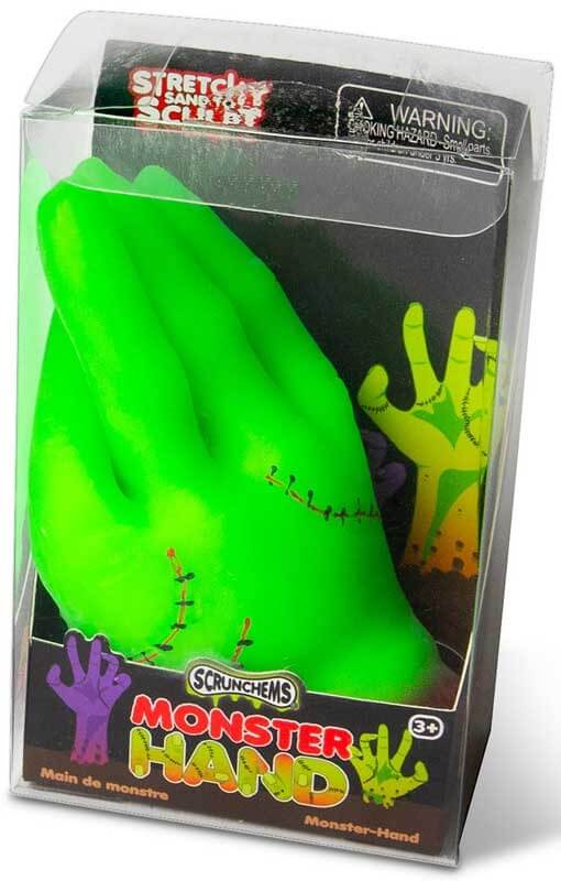 Neon green monster hand toy with black stitch details in clear plastic packaging with purple and green graphics.