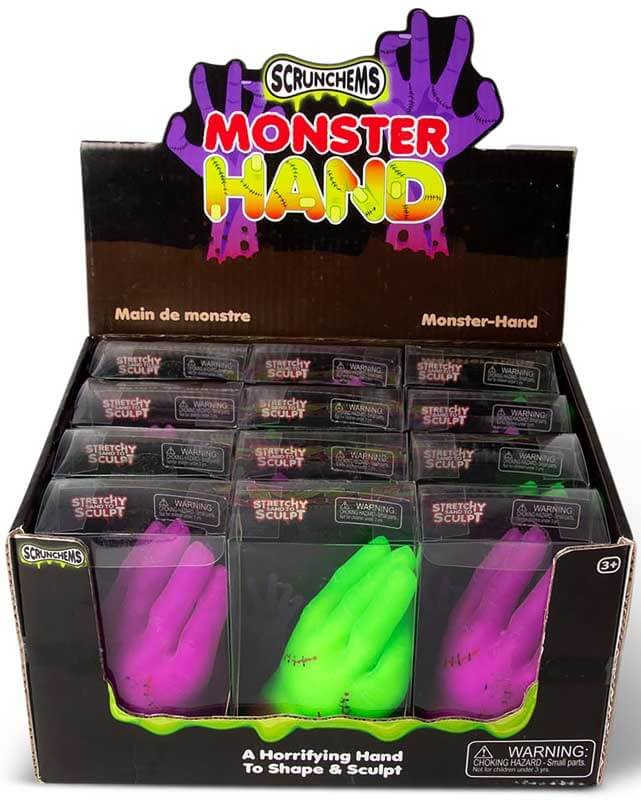 Retail display box filled with bright pink and neon green stretchy monster hands featuring molded stitch details.